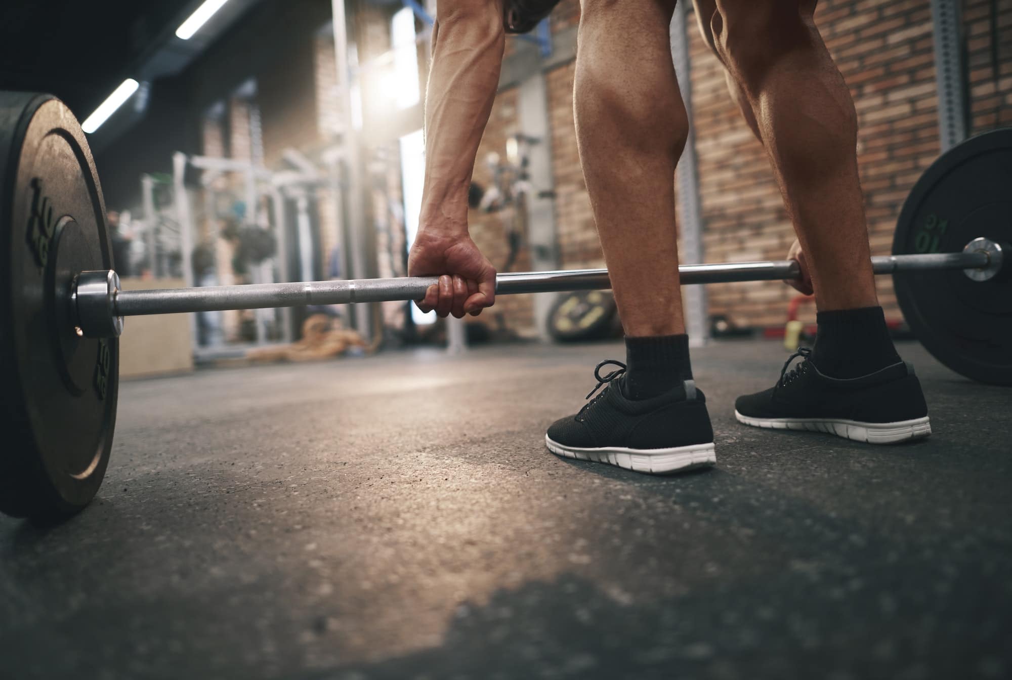 Low section of man doing deadlifts