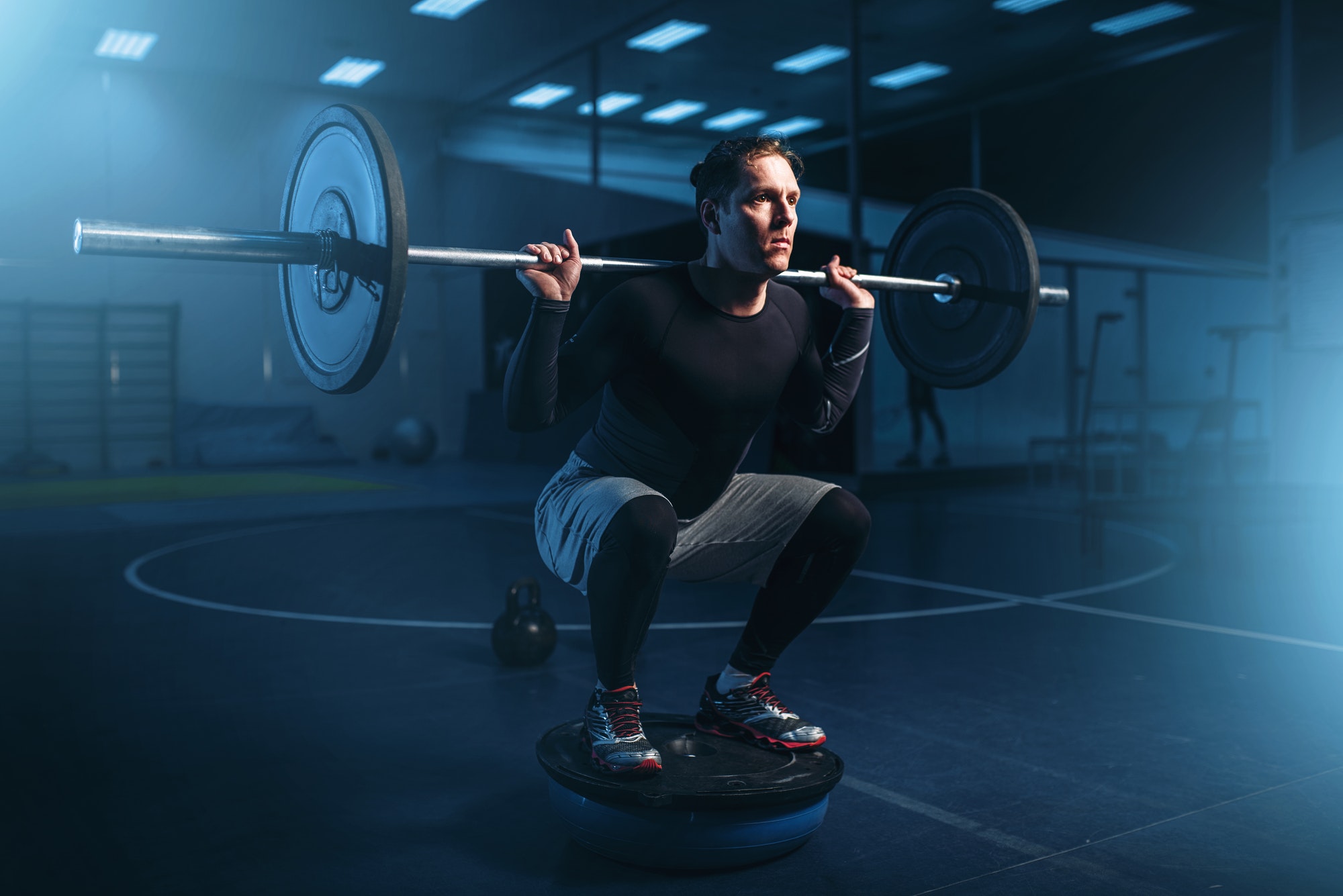 Strength athlete on training, workout with barbell